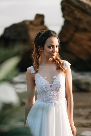 bride on the shore of the black sea in the sunset lightの写真素材