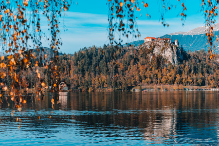 Lake Bled in the Alpine mountains in autumn under blue skyの写真素材
