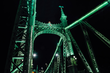 Old Iron Bridge at night in the light of streetlights across the Danube River in Budapest Hungaryの写真素材