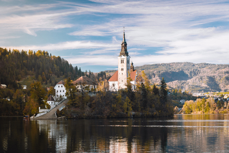 Lake Bled in the Alpine mountains in autumn under blue skyの写真素材