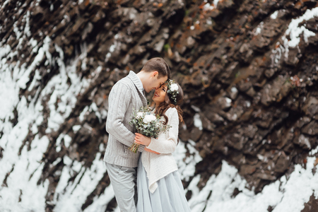 bride and groom on the background of a mountain waterfallの写真素材