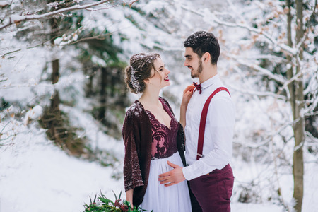 groom in a brown and bride in burgundy in the mountains Carpathiansの写真素材