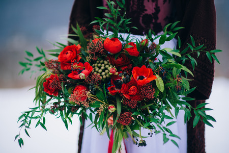 groom in a brown and bride in burgundy in the mountains Carpathiansの写真素材