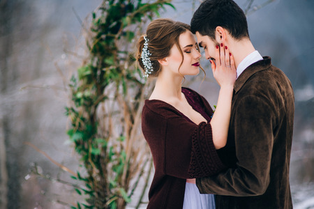 groom in a brown and bride in burgundy in the mountains Carpathiansの写真素材