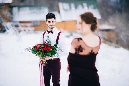 groom in a brown and bride in burgundy in the mountains Carpathiansの写真素材