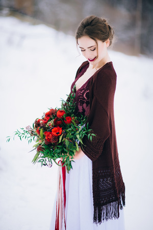 groom in a brown and bride in burgundy in the mountains Carpathiansの写真素材