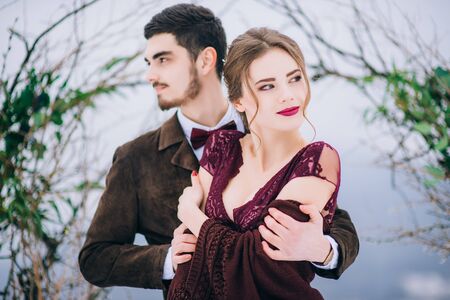 groom in a brown and bride in burgundy in the mountains Carpathiansの写真素材
