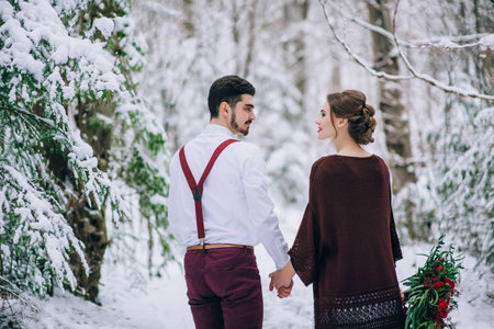 groom in a brown and bride in burgundy in the mountains Carpathiansの写真素材