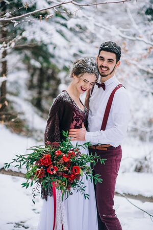 groom in a brown and bride in burgundy in the mountains Carpathiansの写真素材
