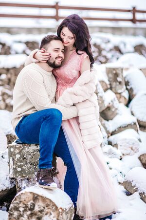 a bride in a fur coat with a fiance among the Carpathian mountainsの写真素材