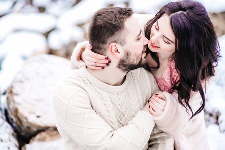 a bride in a fur coat with a fiance among the Carpathian mountainsの写真素材
