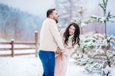 A bride in a fur coat with a fiance among the Carpathian mountainsの写真素材