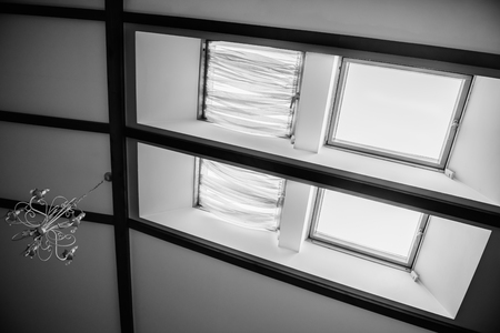 skylights in the roof of the house with a vintage chandelier on the ceiling