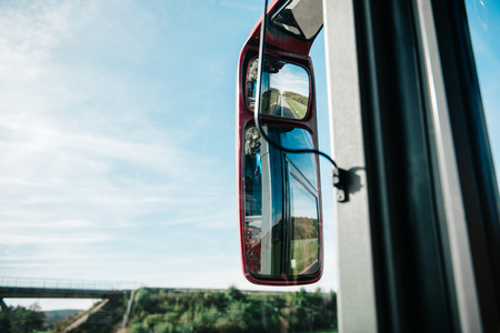 rear-view mirror in the bus riding the european roads of Europeの写真素材