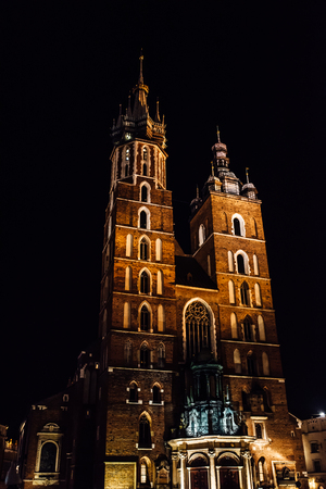 Night old commercial area of Krakow in the lights of street lamps. Old Europe.の写真素材