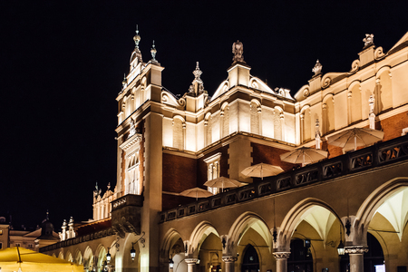 Night old commercial area of Krakow in the lights of street lamps. Old Europe.の写真素材