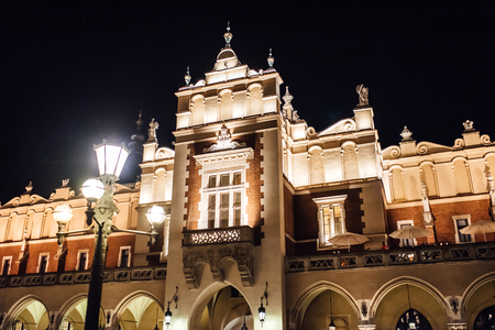 Night old commercial area of Krakow in the lights of street lamps. Old Europe.の写真素材