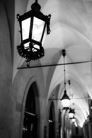 Night old commercial area of Krakow in the lights of street lamps. Old Europe.の写真素材