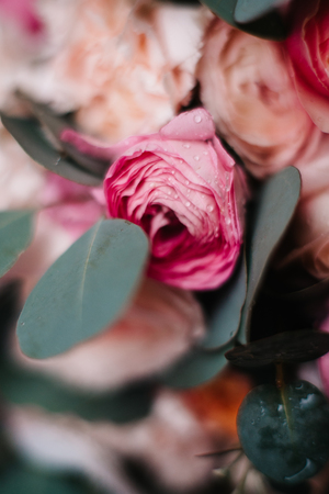 wedding bouquet of peonies with ribbons on stone, close-up, it's snowingの写真素材