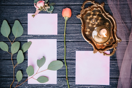 wedding decor with a rose and invitations, on a wooden backgroundの写真素材