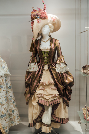 medieval women's dresses on mannequins in a glass case under glassの写真素材