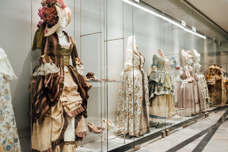 medieval women's dresses on mannequins in a glass case under glassの写真素材