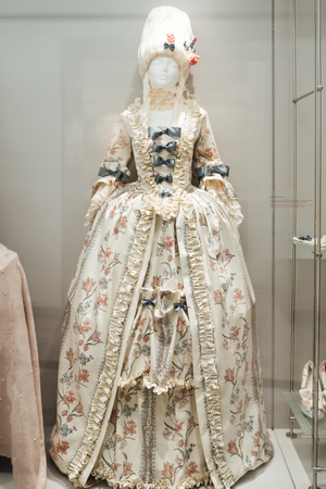 medieval women's dresses on mannequins in a glass case under glassの写真素材