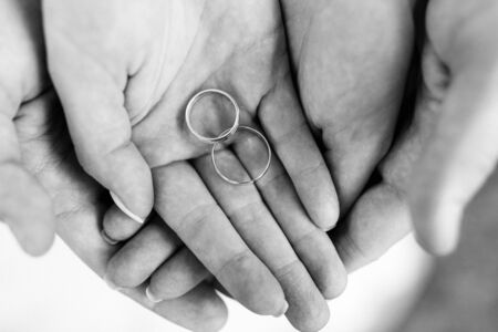 the bride and groom held hands with wedding rings