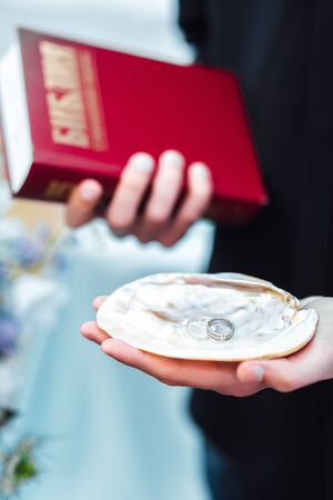 wedding couple on the ocean with a priestの写真素材