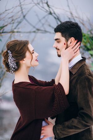 groom in a brown and bride in burgundy in the mountains Carpathiansの写真素材