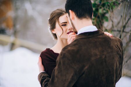 groom in a brown and bride in burgundy in the mountains Carpathiansの写真素材