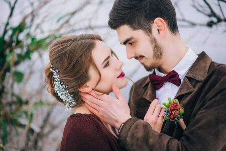 groom in a brown and bride in burgundy in the mountains Carpathiansの写真素材