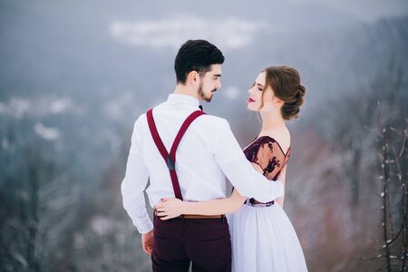 groom in a brown and bride in burgundy in the mountains Carpathiansの写真素材