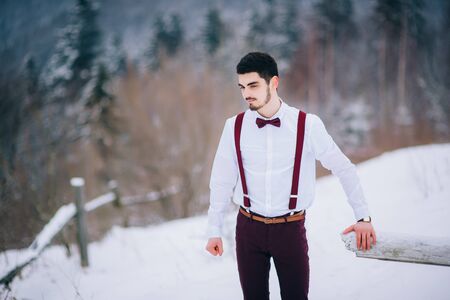 groom in a brown and bride in burgundy in the mountains Carpathiansの写真素材