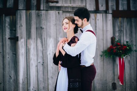 groom in a brown and bride in burgundy in the mountains Carpathiansの写真素材