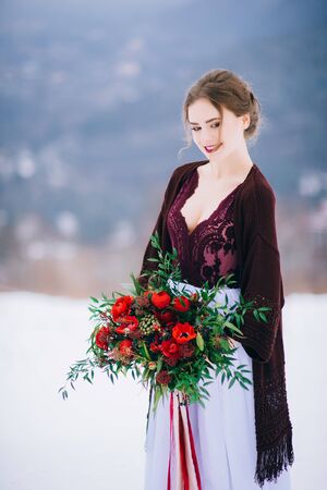 groom in a brown and bride in burgundy in the mountains Carpathiansの写真素材