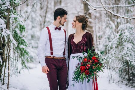 groom in a brown and bride in burgundy in the mountains Carpathiansの写真素材