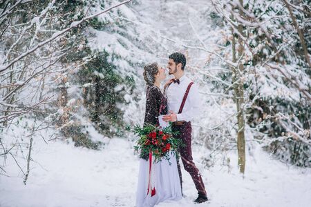 groom in a brown and bride in burgundy in the mountains Carpathiansの写真素材