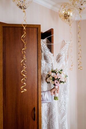 dress up the bride in a wedding dress with corset and lacingの写真素材