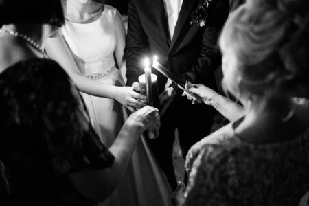 transfer of wedding fire with the help of candles from mothers to the newlywedsの写真素材