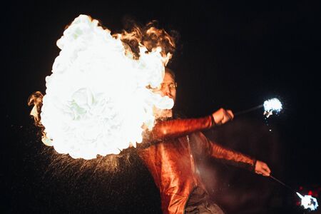 light up the night fire show with the participation of the people, light, and open fireの写真素材