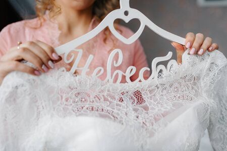 dress up the bride in a wedding dress with corset and lacingの写真素材