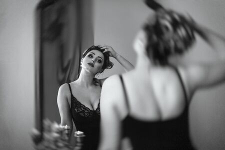 young brunette model girl and actress in front of a mirror, black and whiteの写真素材