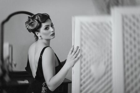 young brunette model girl and actress near the screen, black and whiteの写真素材