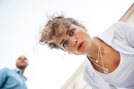 guy and a girl happily walk in the morning on the empty streets of old Europeの写真素材