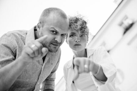 guy and a girl happily walk in the morning on the empty streets of old Europeの写真素材