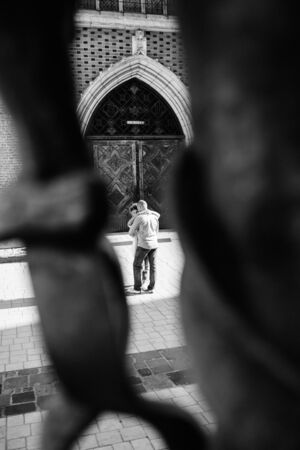 guy and a girl happily walk in the morning on the empty streets of old Europeの写真素材