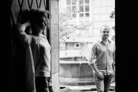 guy and a girl happily walk in the morning on the empty streets of old Europeの写真素材