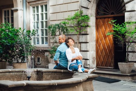 guy and a girl happily walk in the morning on the empty streets of old Europeの写真素材