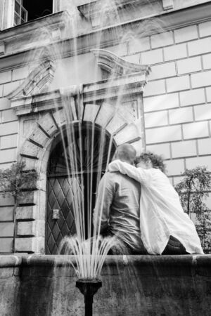 guy and a girl happily walk in the morning on the empty streets of old Europeの写真素材